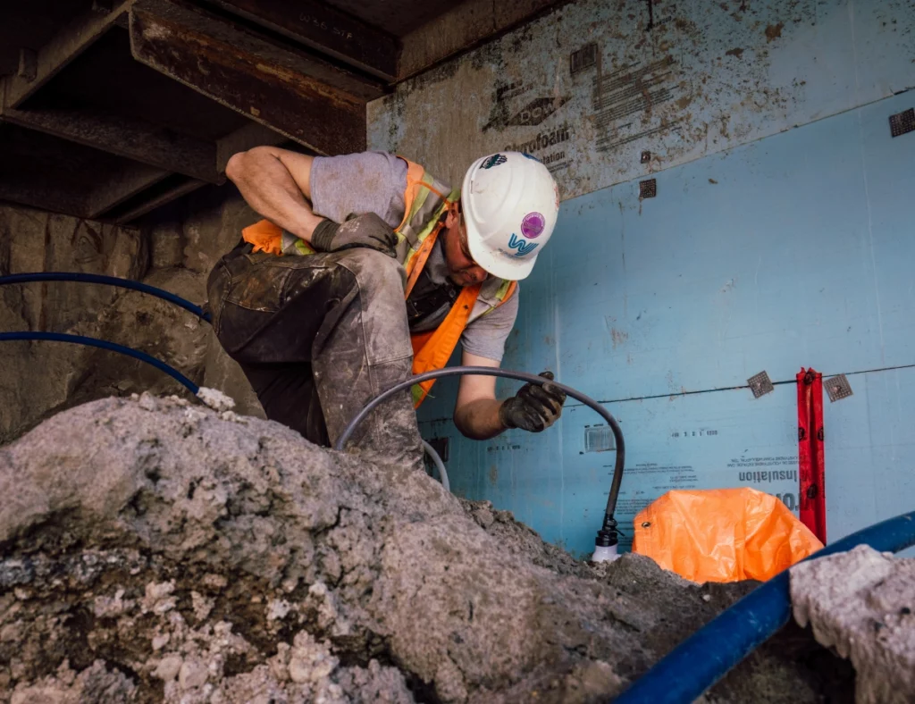 Construction worker digging in debris | groundwater management