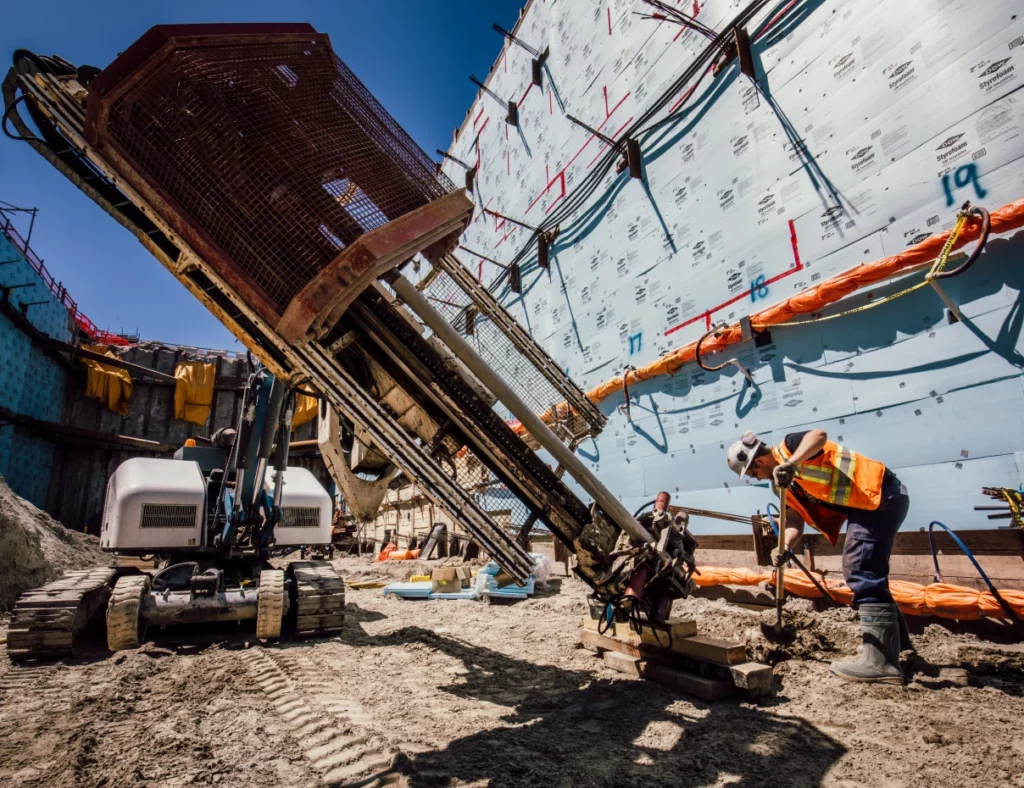 Construction site with heavy machinery in use for well drilling with WJ Canada.