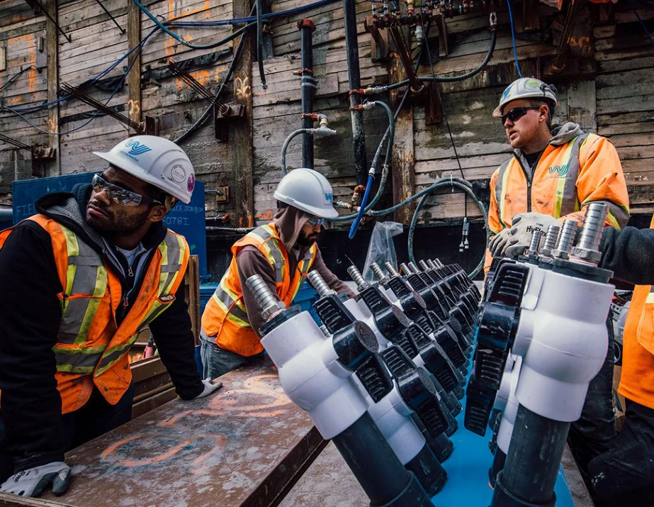 Construction workers with machinery equipment.